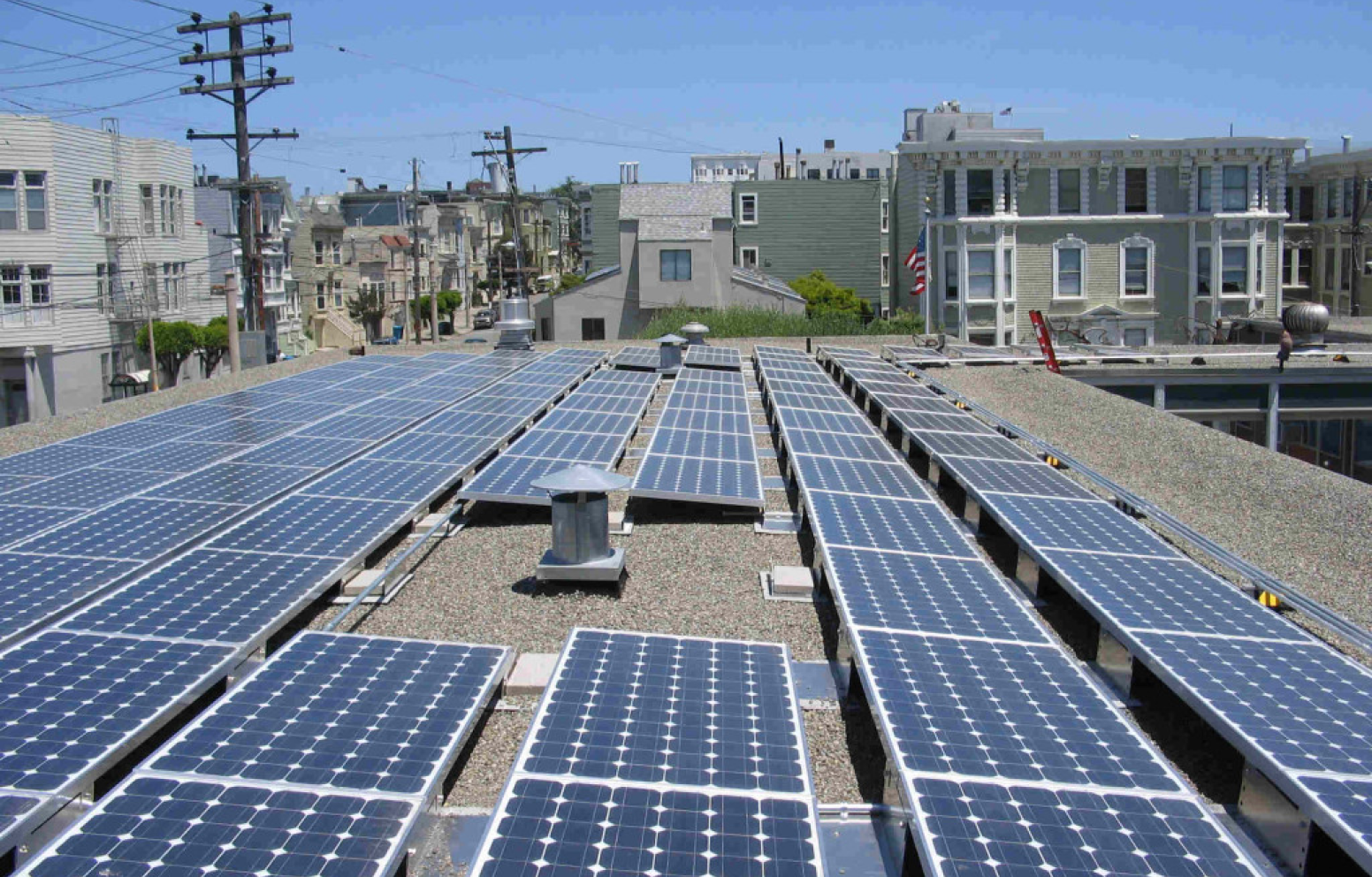 American Solar Partners with a solar panel installation on a flat roof with rocks, sand and pebbles for a commercial client