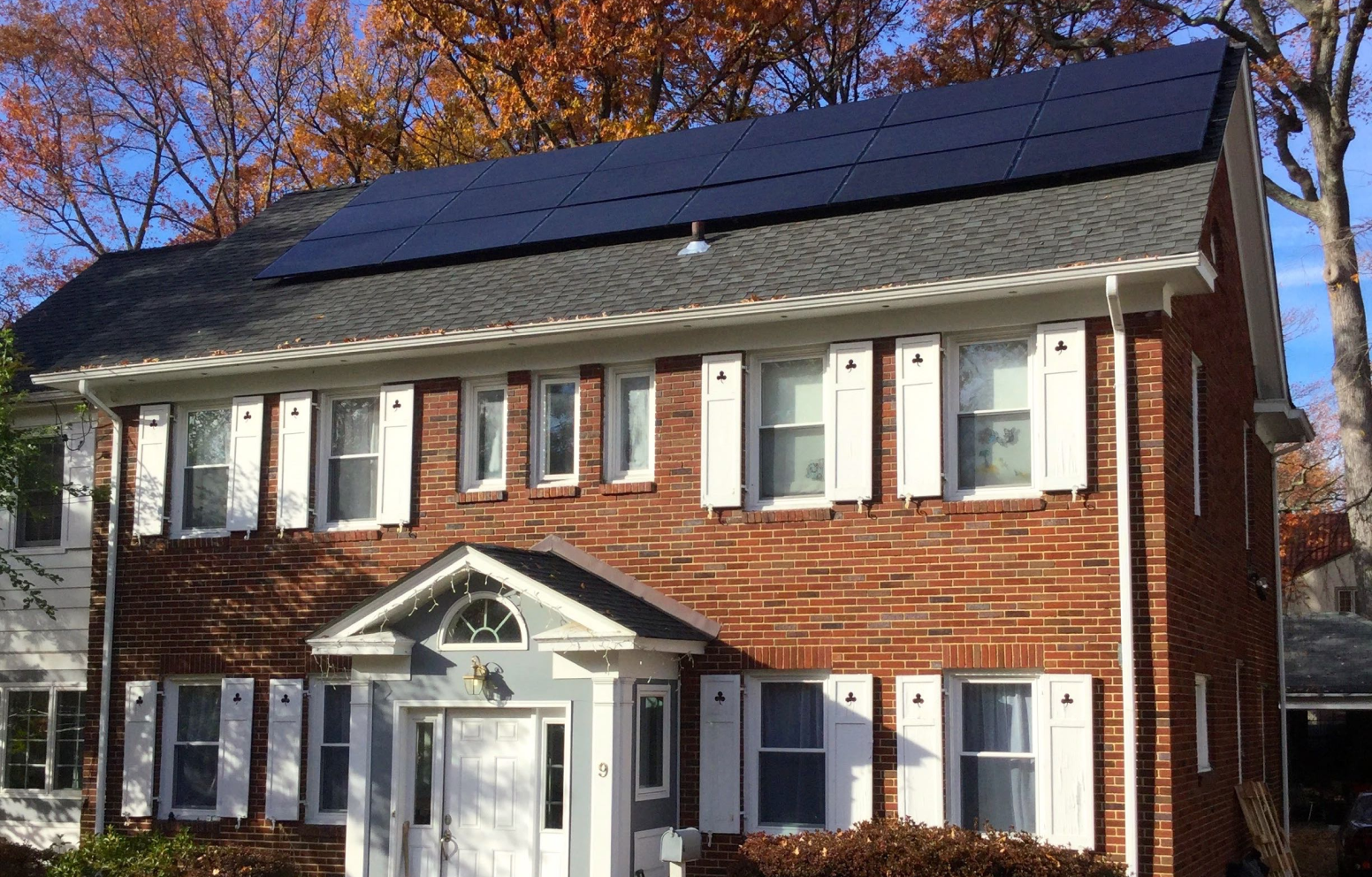 American Solar Partners - Slanted solar panel installation on the front of a slanted residential roof surrounding a vent